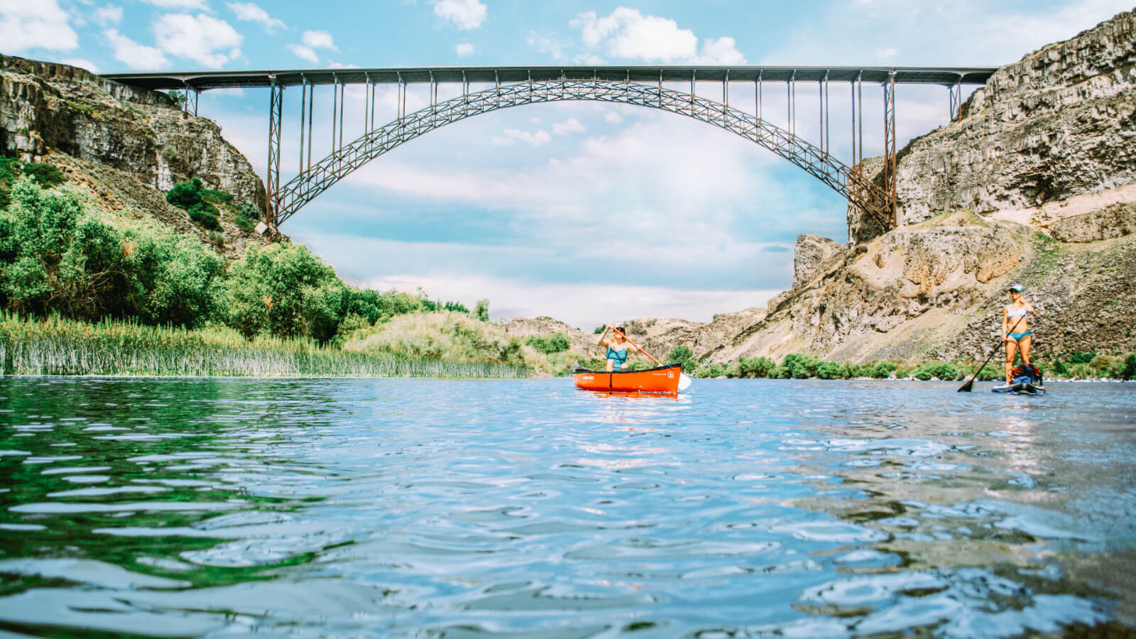 Person canoeing and person paddle boarding